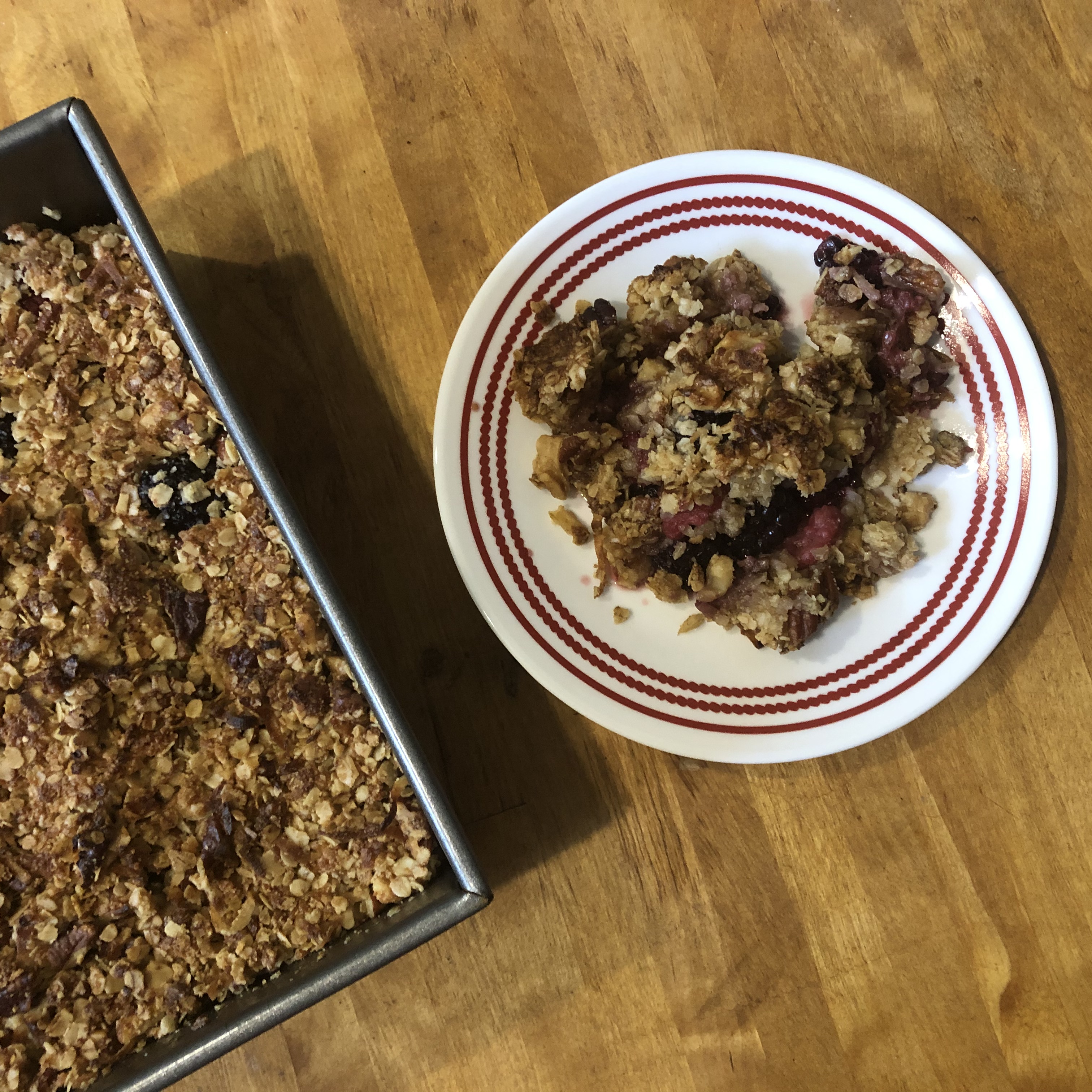 Blueberry crisp in pan and piece on plate