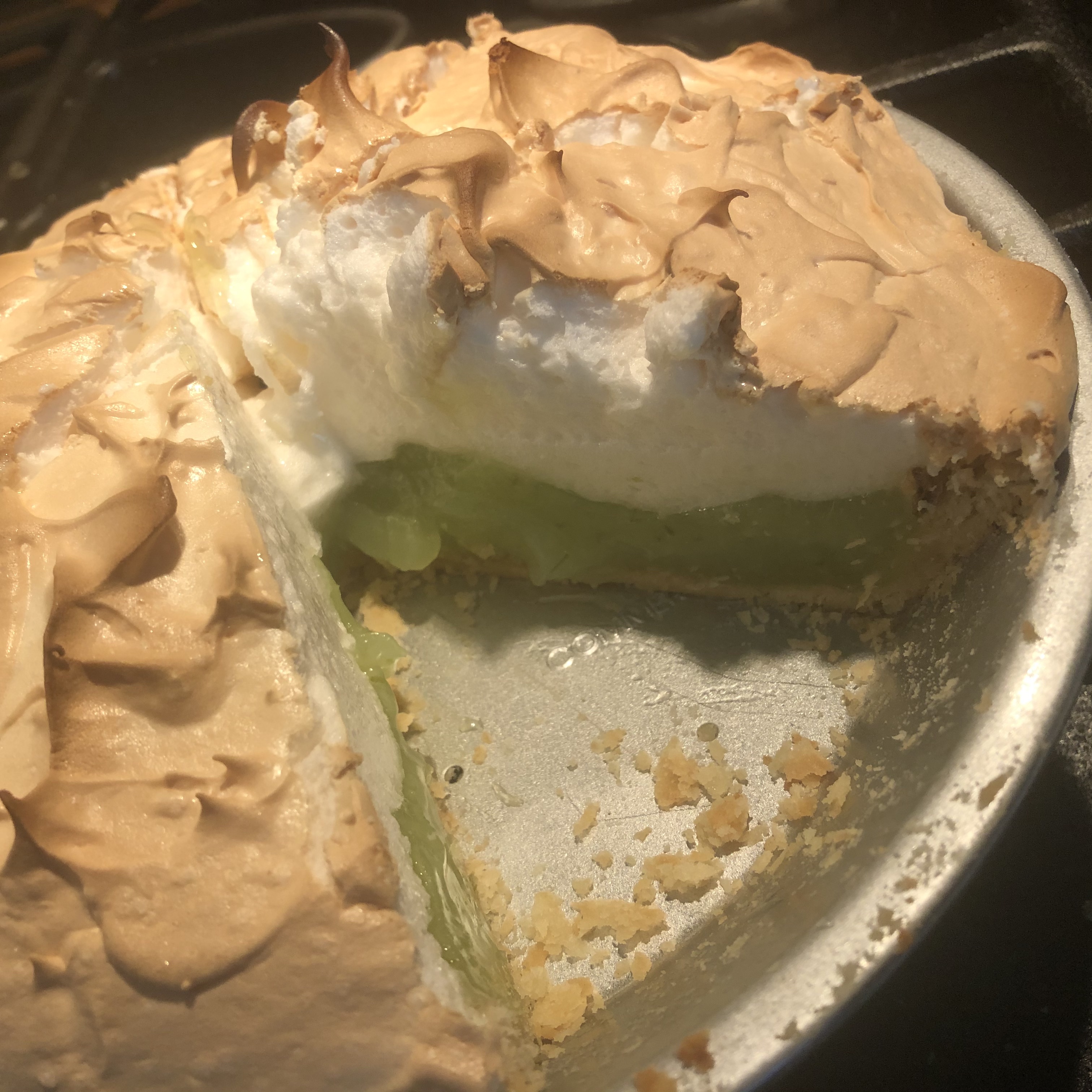 Lime meringue pie with one piece removed