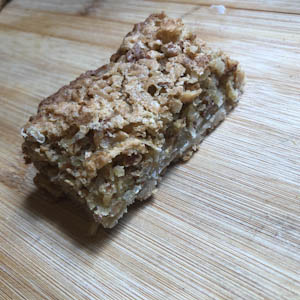 A piece of Cocount Almond Toffee Bar on a plate